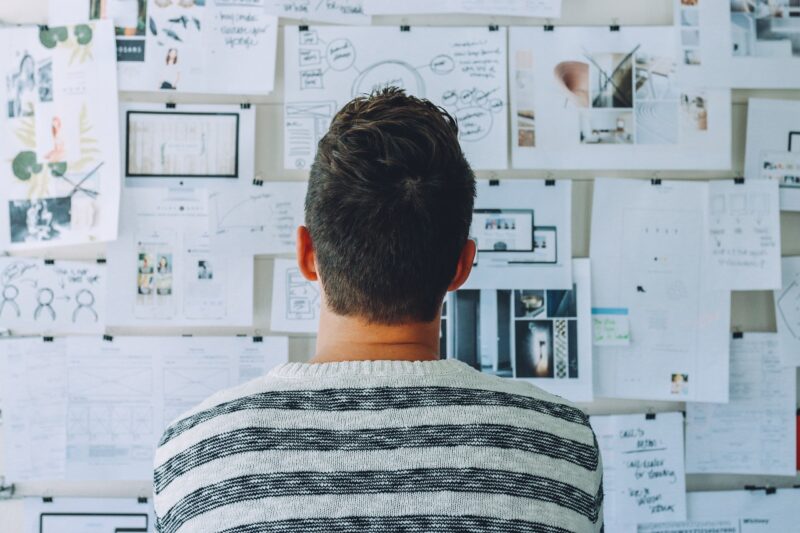 man reading a bulletin board